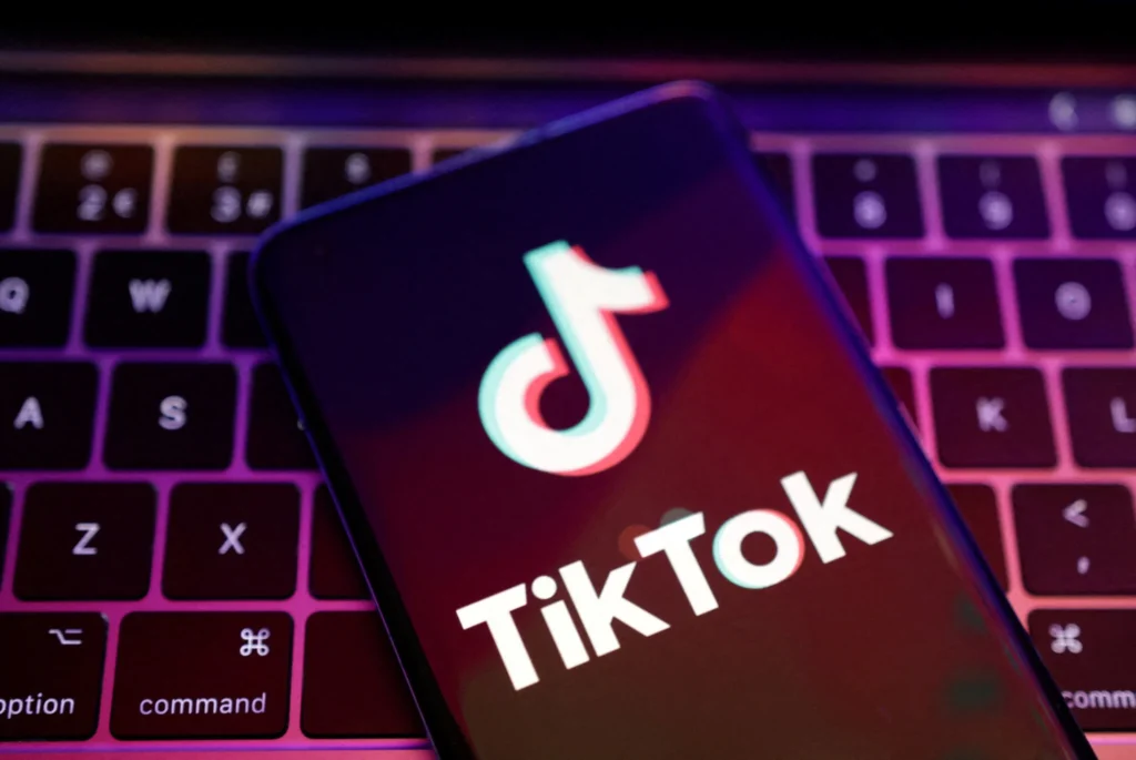 TikTok logo on smartphone screen - TikTok Crypto Marketing in 2025: The Human Way to Go Viral